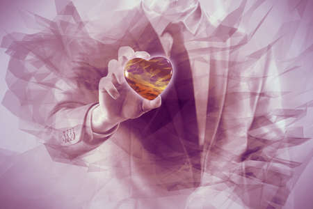 Businessman holding red heart in medical conceptの写真素材