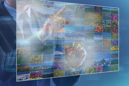 Man pressing buttons with nature photos