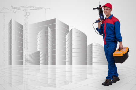 Man with drill against hand-drawn buildings