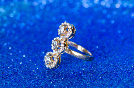 Jewellery ring against blue background