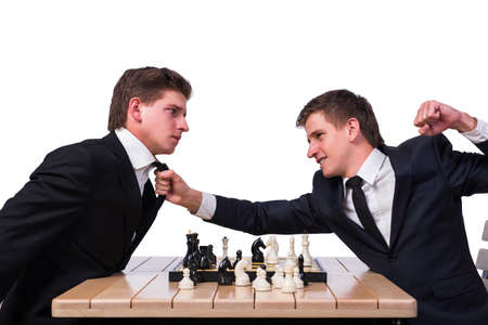 Twin brothers playing chess isolated on white