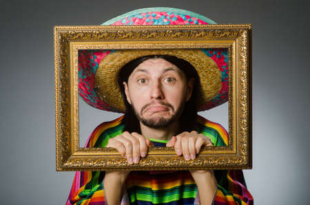 Mexican man with sombrero and picture frameの写真素材