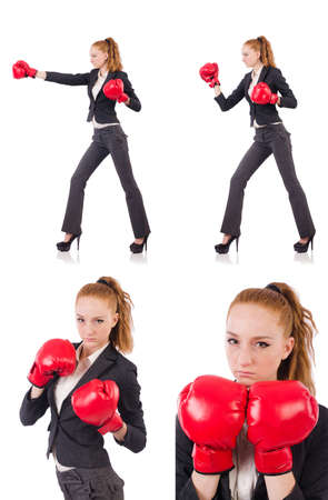 Woman businesswoman with boxing gloves on whiteの写真素材