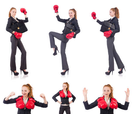 Woman businesswoman with boxing gloves on whiteの写真素材