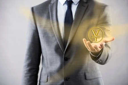 Man pressing buttons with japanese yenの写真素材