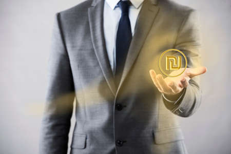 Man pressing buttons with israeli shekelの写真素材