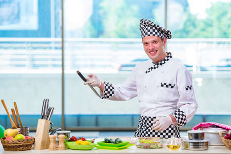 Male cook preparing food in the kitchenの写真素材