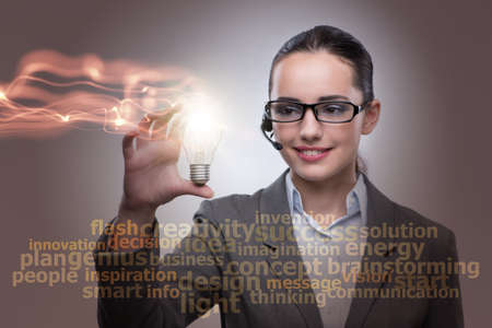 Young call center operator with bulb in idea conceptの写真素材