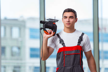 Young carpenter working at construction site