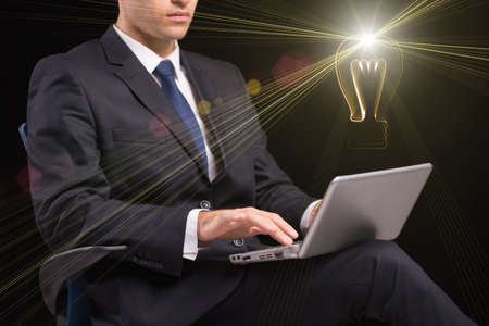 Young businessman with laptop and lamp idea concept