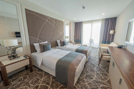 Modern hotel room with big bedの写真素材