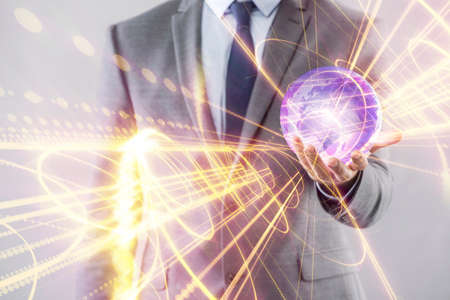 Young businessman in globalisation concept holding earthの写真素材