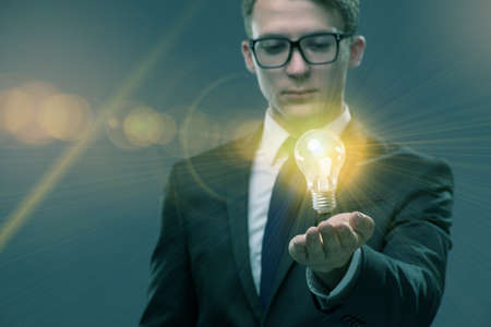 Young businessman with light bulb in idea conceptの写真素材