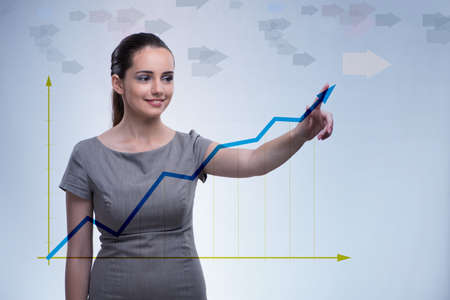 Young businesswoman with chart diagramsの写真素材