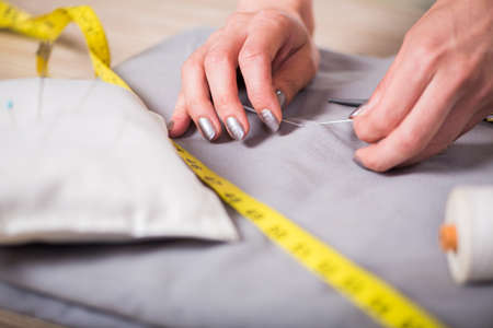 Tailor hands working on new clothing