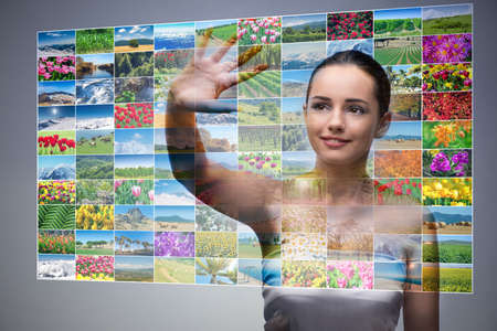 Businesswoman pressing virtual button on nature collageの写真素材