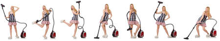 Young woman with vacuum cleaner on whiteの写真素材