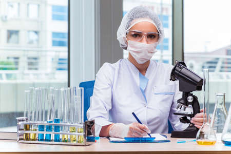 Young student working with chemical solutions in lab