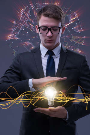 Young businessman with light bulb in idea conceptの写真素材