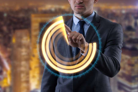 Businessman pressing virtual buttons in futuristic conceptの写真素材