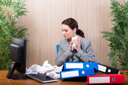 Busy businesswoman in the office under stressの写真素材