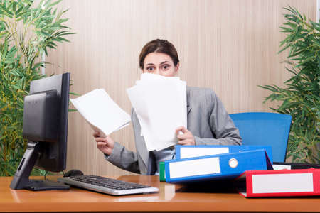 Busy businesswoman in the office under stress