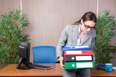 Busy businesswoman in the office under stressの写真素材
