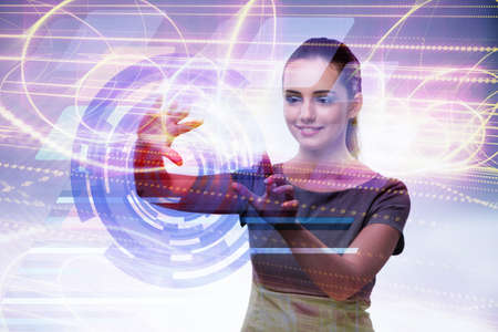 Businesswoman pressing virtual buttons in futuristic conceptの写真素材