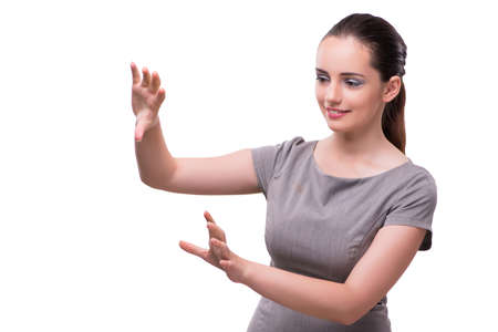 Young businesswoman pressing virtual button isolated on whiteの写真素材