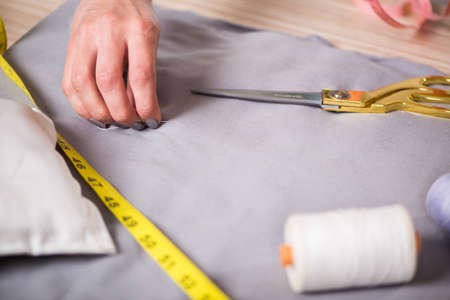Tailor hands working on new clothing