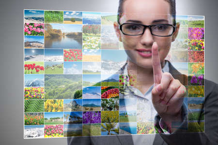 Businesswoman pressing virtual button on nature collageの写真素材