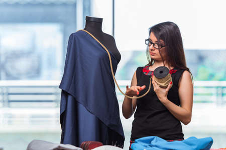 Woman tailor working on new clothing