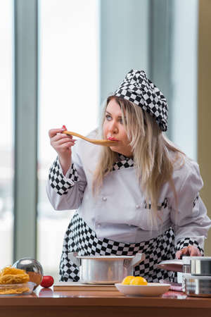 Young chef cook working in the kitchenの写真素材