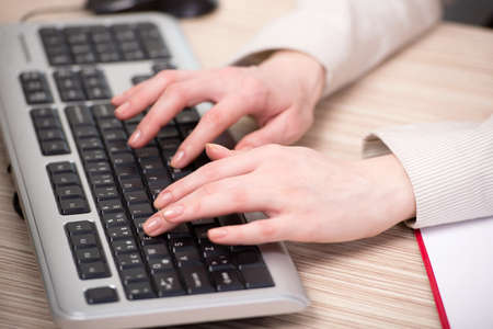 Hands working on the keyboard in the office