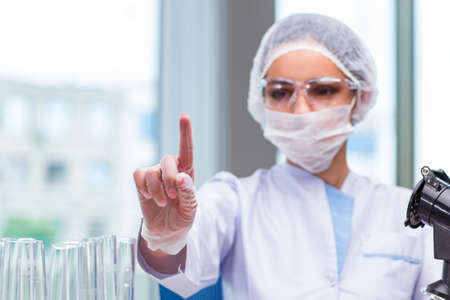 Young student working with chemical solutions in labの写真素材