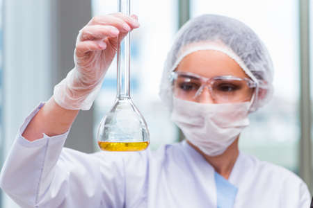 Young student working with chemical solutions in lab