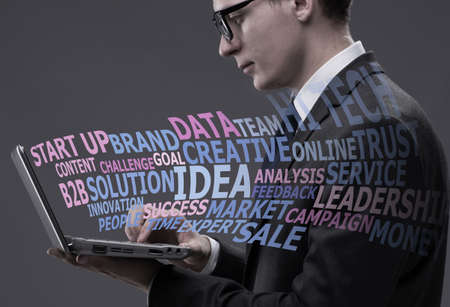 Young businessman with laptop in business conceptの写真素材