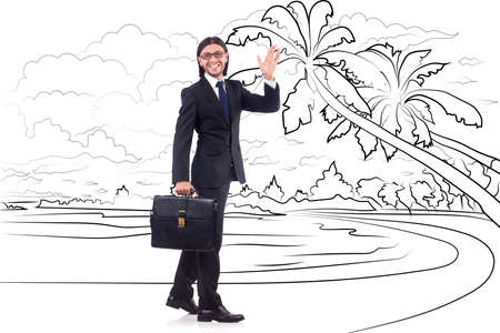 Young businessman dreaming of beach vacationの写真素材