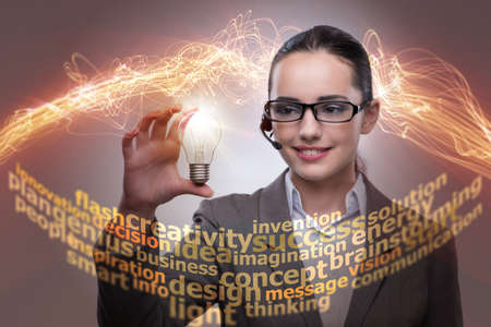 Young call center operator with bulb in idea conceptの写真素材