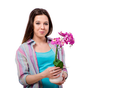 Young woman taking care of plants isolated on whiteの写真素材