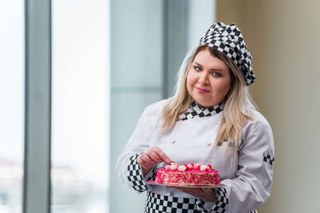 Young woman chef preparing dessert cakの写真素材