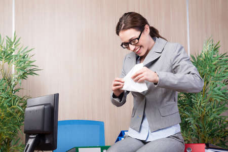 Office woman making paper airplanesの写真素材