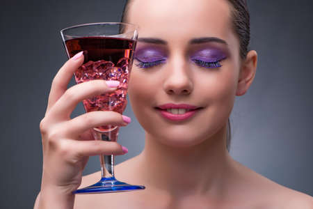 Nice woman drinking red cocktailの写真素材