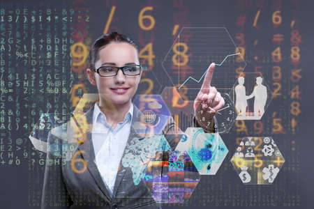 Woman pressing buttons in business conceptの写真素材