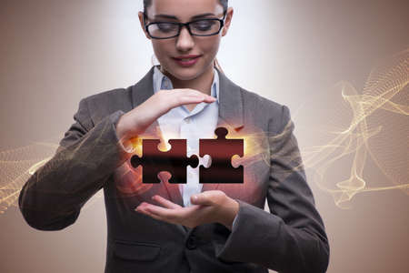 Businesswoman in business concept with puzzle pieceの写真素材