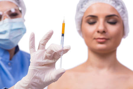 Young woman preparing for injection of botox isolated on whiteの写真素材
