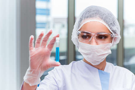 Young student working with chemical solutions in lab