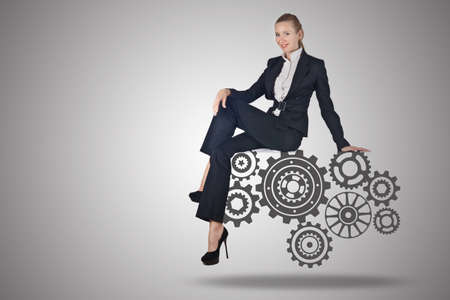 Busineswoman with cogwheels gear in teamwork conceptの写真素材