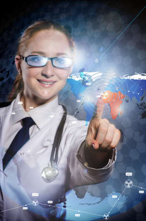 Woman doctor pressing buttons with various medical iconsの写真素材