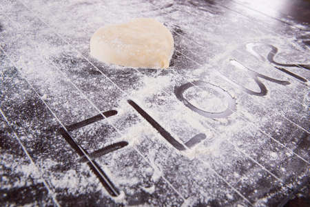 Cook preparing dough for baking in the kitchenの写真素材